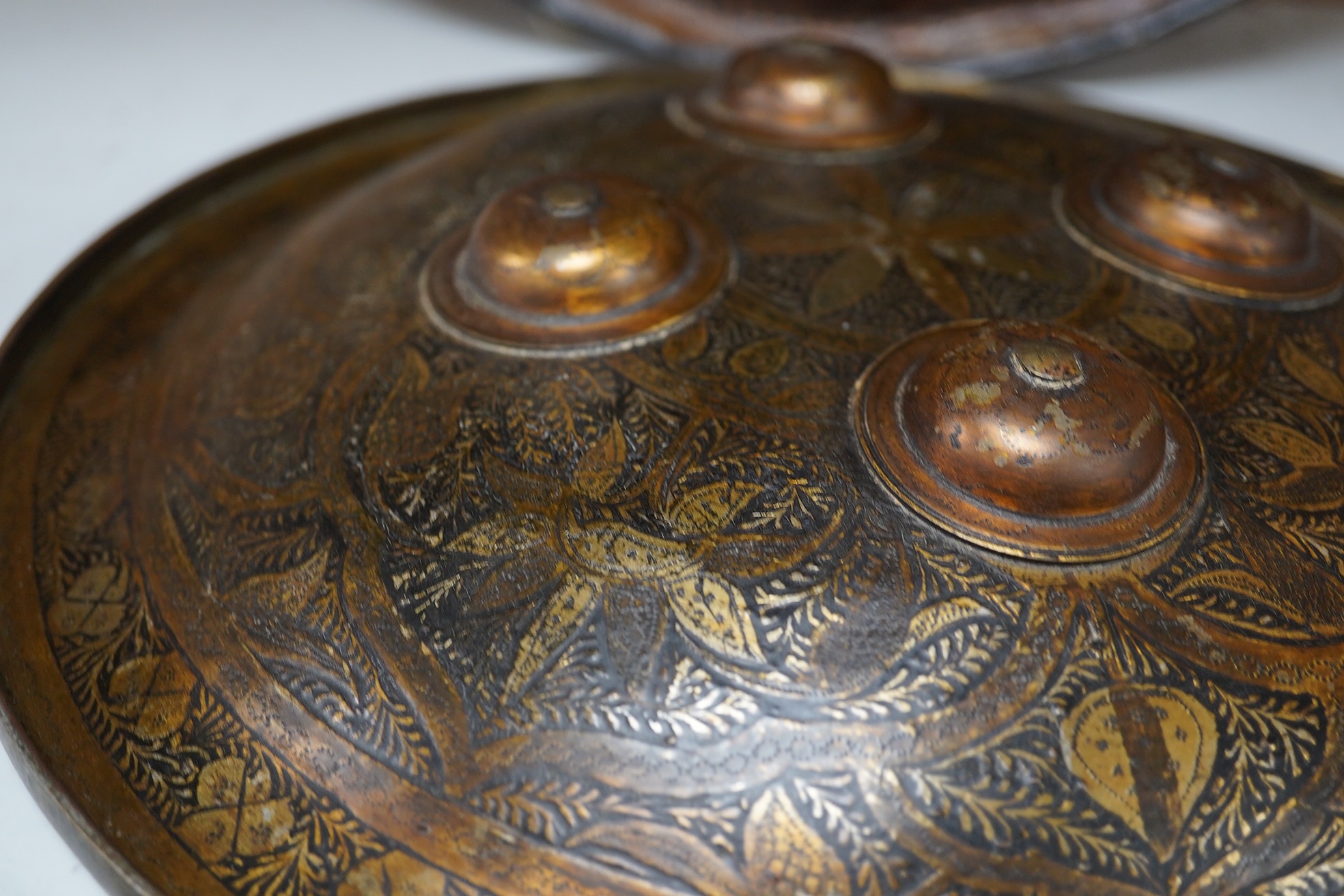 Two Persian style shields, one papier mache the other metal, largest 34cm diameter. Condition - good